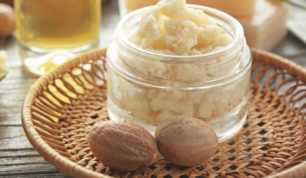 Shea butter in glass jar, natural setting.