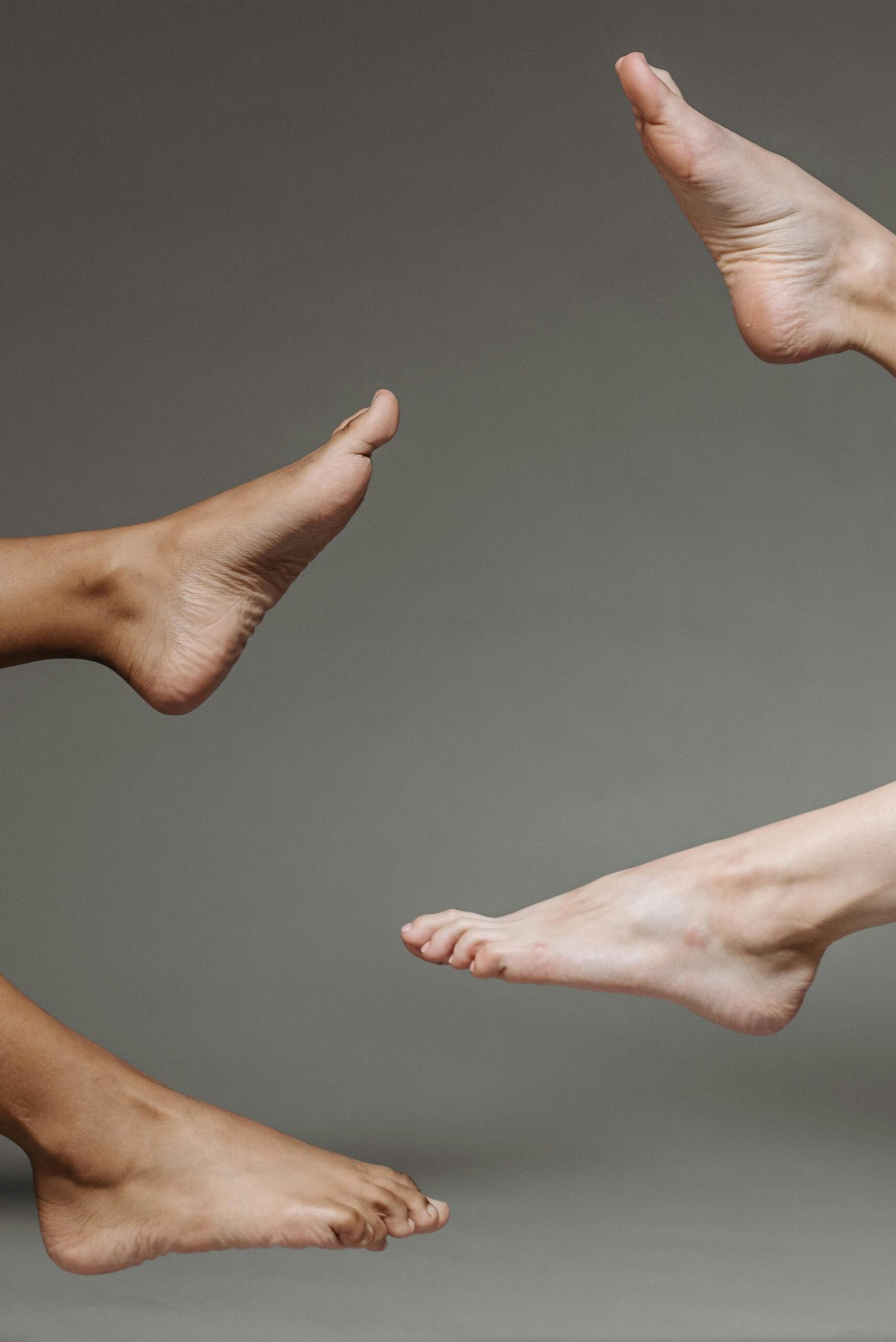 Different feet representing blog about body butters for dry feet and if you can use body butters for feet.