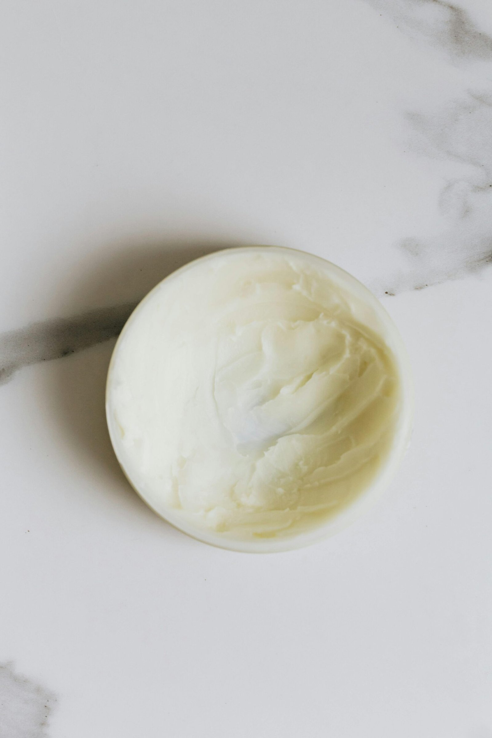 Top image of body butter on marble representing the blog Why Night-Time Is the Best Time to Use Body Butter (And Most People Miss This)