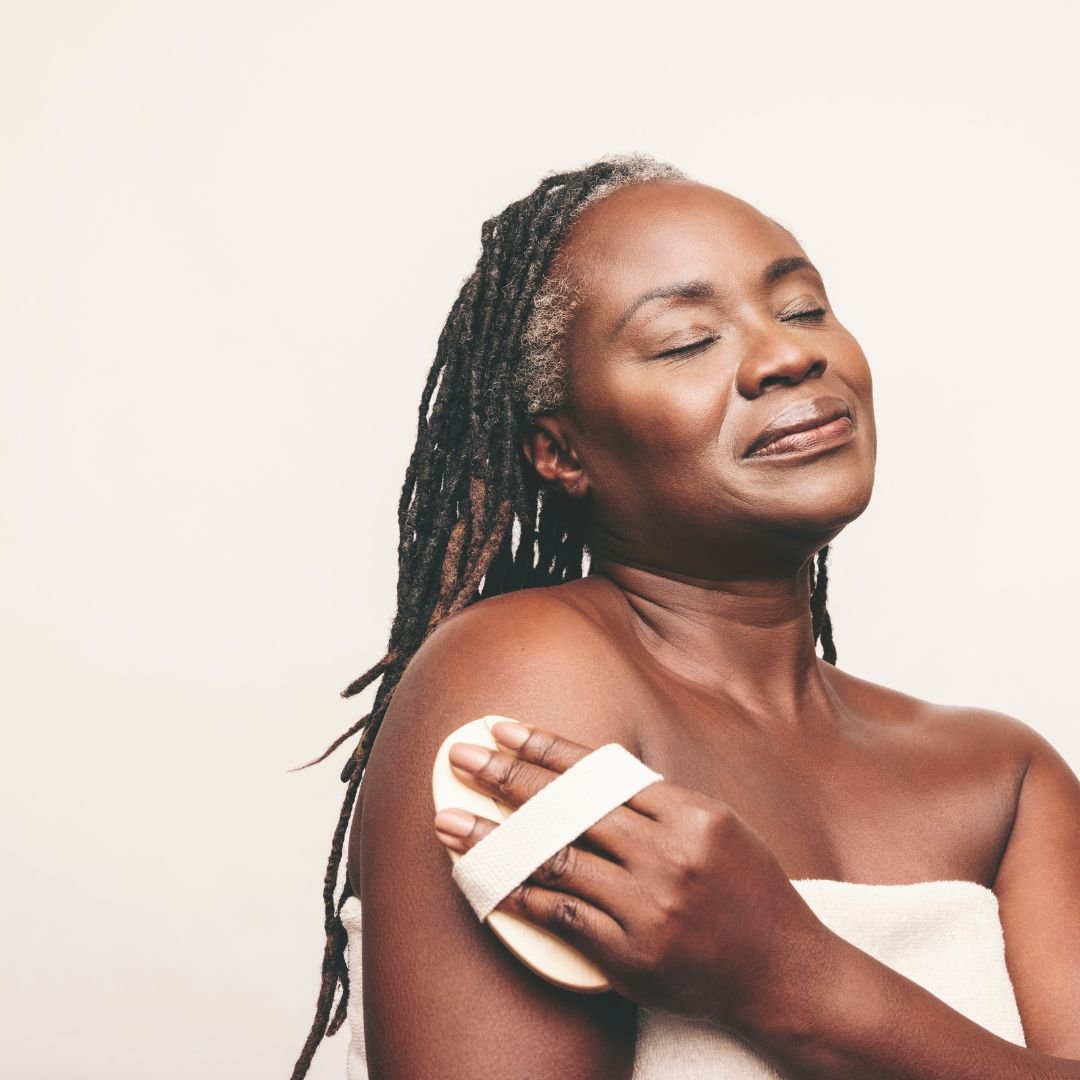 Woman of colour representing women in 40s with dry sensitive skin with bath robe and scrub.